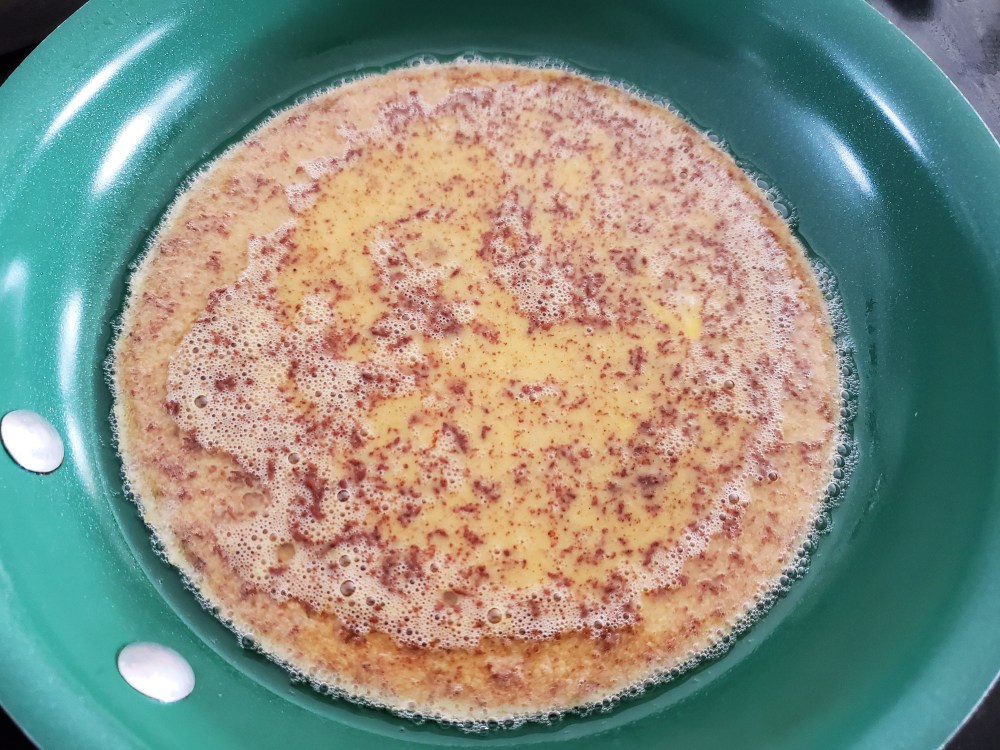 Raw batter just poured into skillet containing coconut oil.
